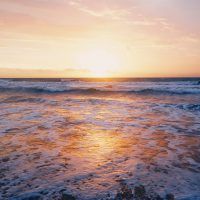 photo-of-ocean-waves-near-seashore-during-sunset-982673